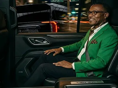 Passenger enjoying premium black car service inside a luxury executive GMC Yukon Denali SUV in Edmonton